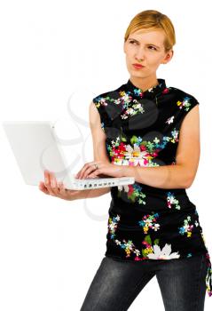 Caucasian woman using a laptop and thinking isolated over white
