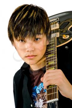 Teenage boy holding a guitar and posing isolated over white