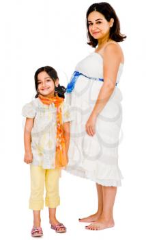 Pregnant woman smiling with her daughter and posing isolated over white