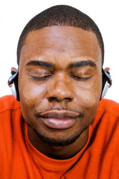 Smiling man wearing headphones and listening to music isolated over white