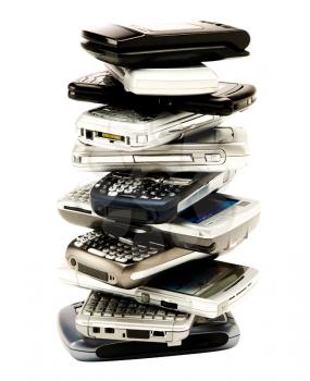Stack of mobile phones isolated over white