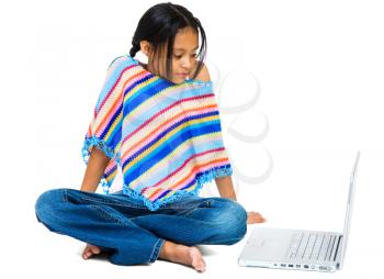 Girl sitting near a laptop isolated over white