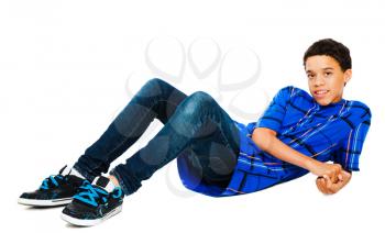 Teenage boy reclining on the floor isolated over white