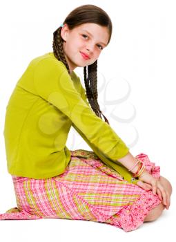 Smiling girl kneeling and posing isolated over white