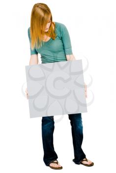 Young woman showing a placard and posing isolated over white