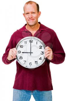 Confident mature man showing a clock isolated over white