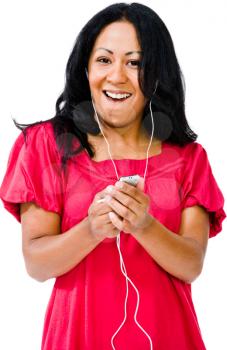 Portrait of woman listening to music on MP3 player isolated over white
