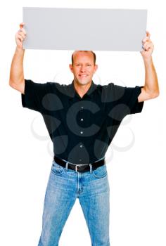 Man showing an empty placard and smiling isolated over white