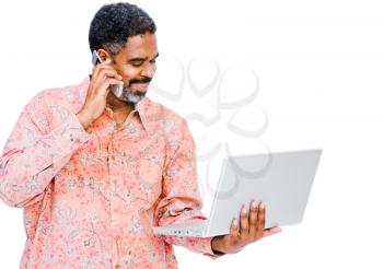 Man using a laptop and a mobile phone isolated over white