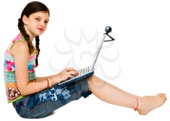 Happy girl using a laptop and smiling isolated over white