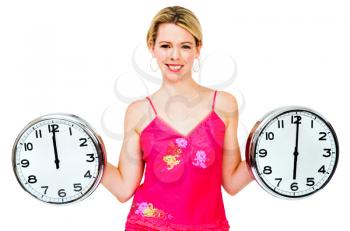 Happy woman holding clocks and posing isolated over white