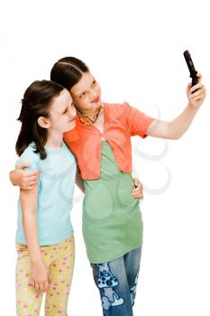 Girls photo messaging on a mobile phone isolated over white
