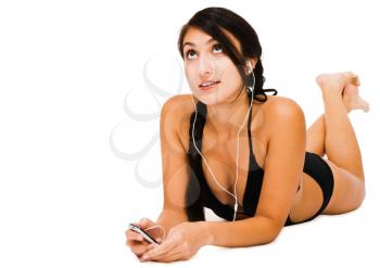 Woman listening to music on MP3 player and smiling isolated over white