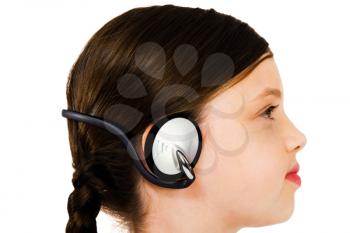 Confident girl listening to music on headphones isolated over white