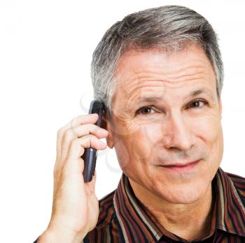 Portrait of a businessman talking on a mobile phone isolated over white