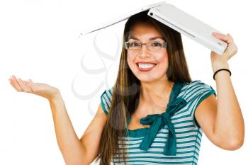 Woman holding a laptop and smiling isolated over white