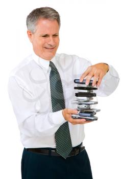Businessman holding a stack of phones isolated over white