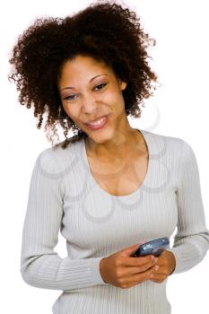 Portrait of a woman using a PDA and smiling isolated over white