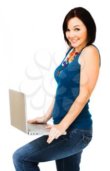 Portrait of a young woman holding a laptop isolated over white