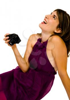 Close-up of a woman holding a camera and laughing isolated over white