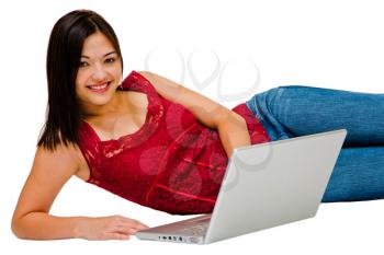 Caucasian woman using a laptop and smiling isolated over white