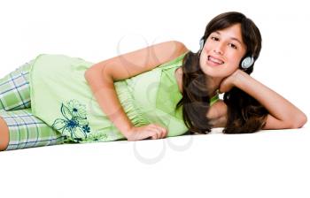 Happy teenage girl wearing headphones and listening to music isolated over white