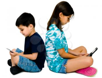 Sister and brother text messaging on mobile phones isolated over white 