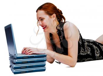 Gorgeous woman using a laptop and smiling isolated over white