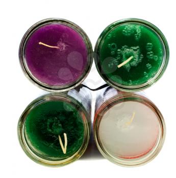 Four colorful candles isolated over white