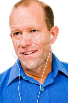 Close-up of a man listening to music and smiling isolated over white