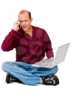Man using a laptop and a mobile phone isolated over white