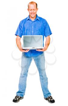 Smiling mature man showing a laptop isolated over white