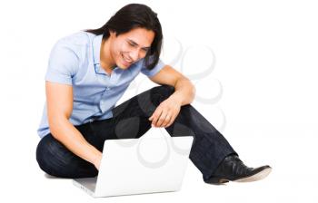 Latin American man using a laptop isolated over white