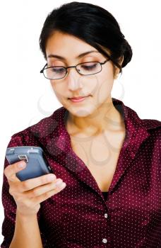 Confident woman text messaging on a mobile phone isolated over white