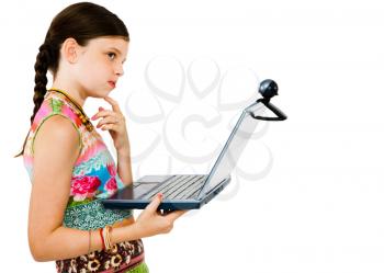 Child using a laptop and thinking isolated over white