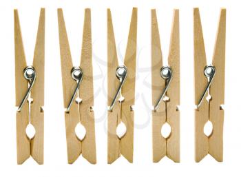 Wooden clothespins in a row isolated over white