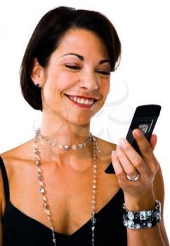 Smiling woman text messaging on a mobile phone isolated over white