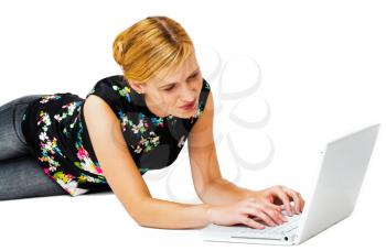 Confident woman using a laptop and smiling isolated over white