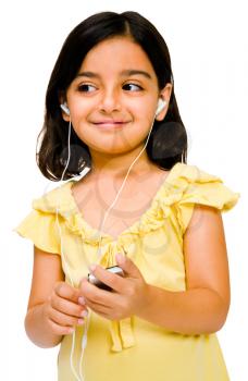 Child listening to music on a MP3 player isolated over white