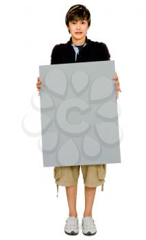 Teenage boy showing an empty placard and posing isolated over white
