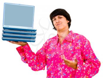 Smiling young man holding laptops and posing isolated over white