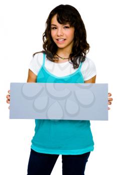 Smiling teenage girl showing an empty placard isolated over white