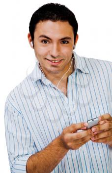 Happy man listening to music on a MP3 player isolated over white