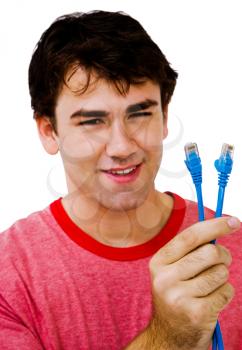 Smiling man holding computer cables isolated over white