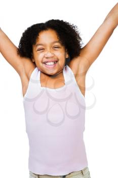 Happy girl standing with her arms raised isolated over white