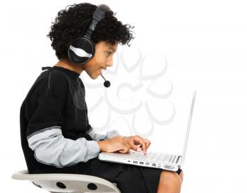Boy surfing the net and smiling isolated over white