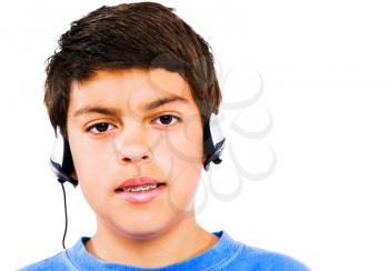Caucasian boy listening to music with headphones isolated over white