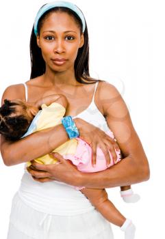 Smiling woman carrying her daughter and posing isolated over white