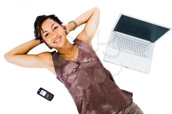 Fashion model lying near a laptop isolated over white