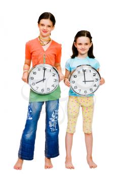 Portrait of girls holding clocks isolated over white